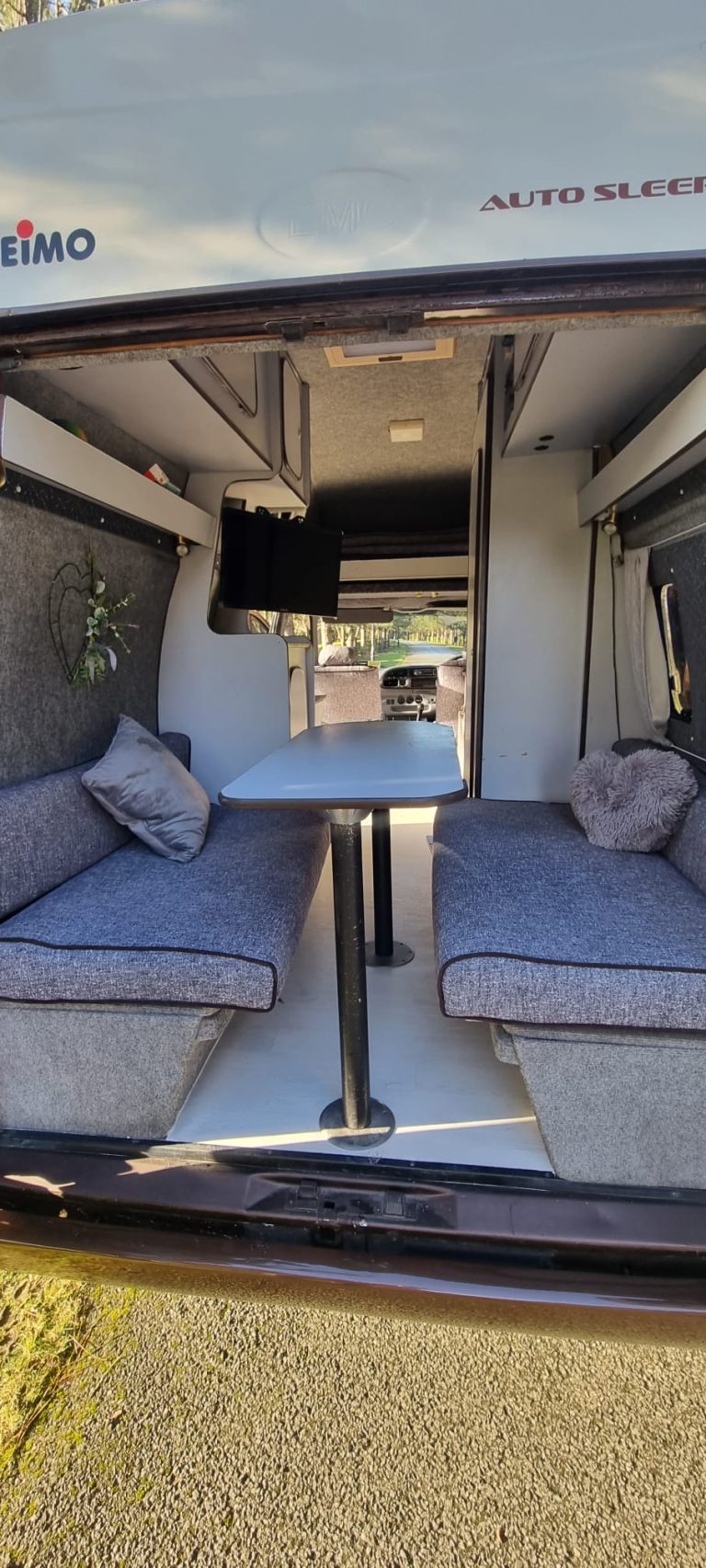 Bertha rear lounge with facing bench seats and a table