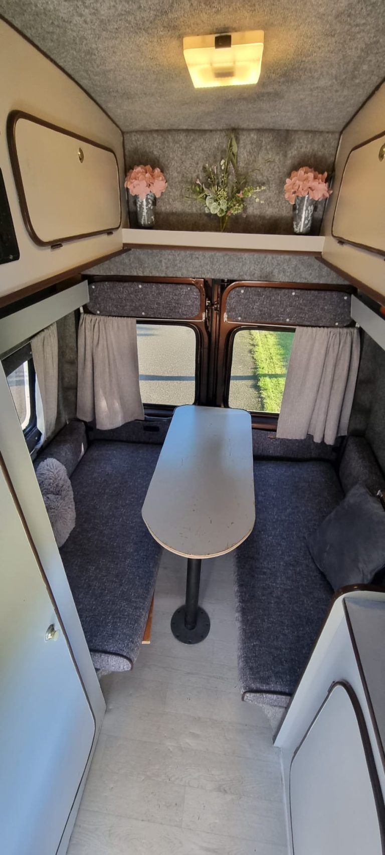 Bertha rear dining area with a table and facing bench seats
