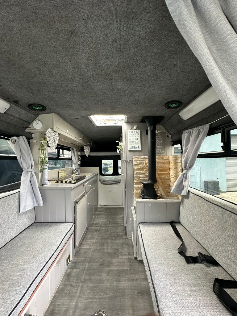 Stella interior with facing bench seats, kitchen and rear bunks
