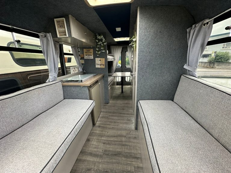 Grande interior with facing bench seats and a central kitchen
