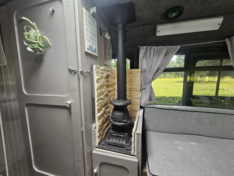 Stella stove and flue beside the lounge bench