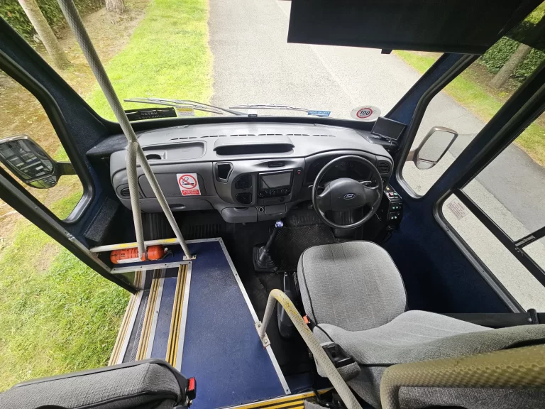 Grande driving cab with the steering wheel and entrance steps